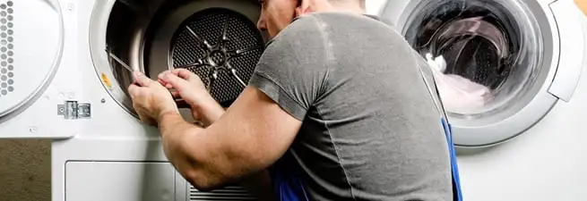 Dryer repair technician fixing a clothes dryer drum in Chattanooga, TN