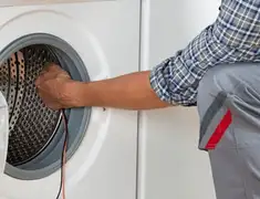 Dryer repair technician diagnosing and servicing a clothes dryer in Chattanooga, TN