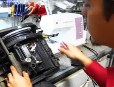 Vacuum repair technician servicing internal components on a workbench in Chattanooga, TN